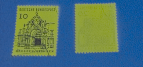 Stamps glowing under UV light, illustrating fluorescent tagging